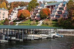 Covered marina docks below lakefront condominiums