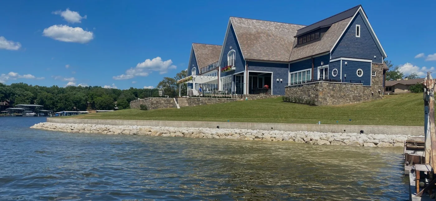 Riprap protecting the shoreline below a lakefront home