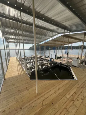 Covered dock interior with metal framing and a boat slip