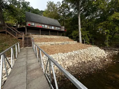 Freshly placed shoreline rock beside a dock walkway