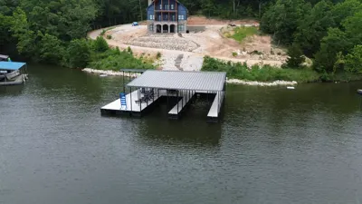 Covered dock and rock-armored bank viewed from the water